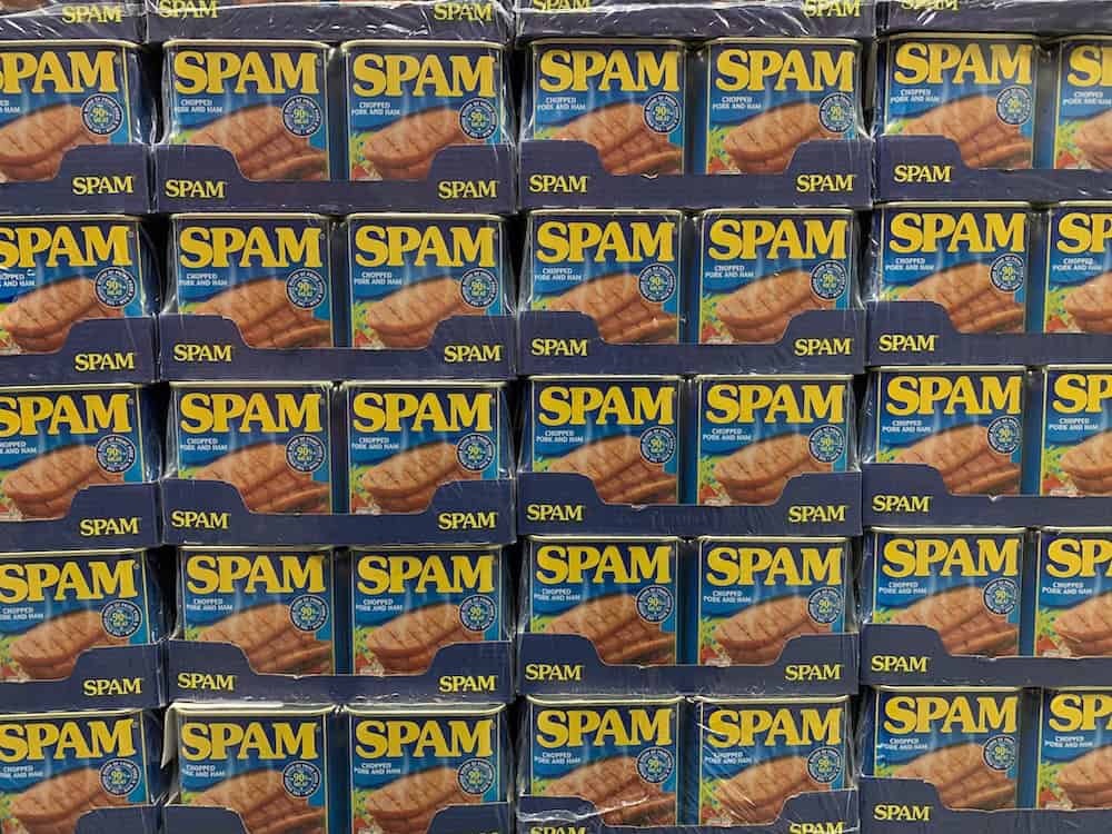 Stacks of SPAM cans are arranged in rows, their blue packaging and yellow SPAM logo prominent—much like efforts to block unwanted words from Elementor forms, ensuring only the best content makes it through. - Clio Websites | Top Canadian Web Design Company